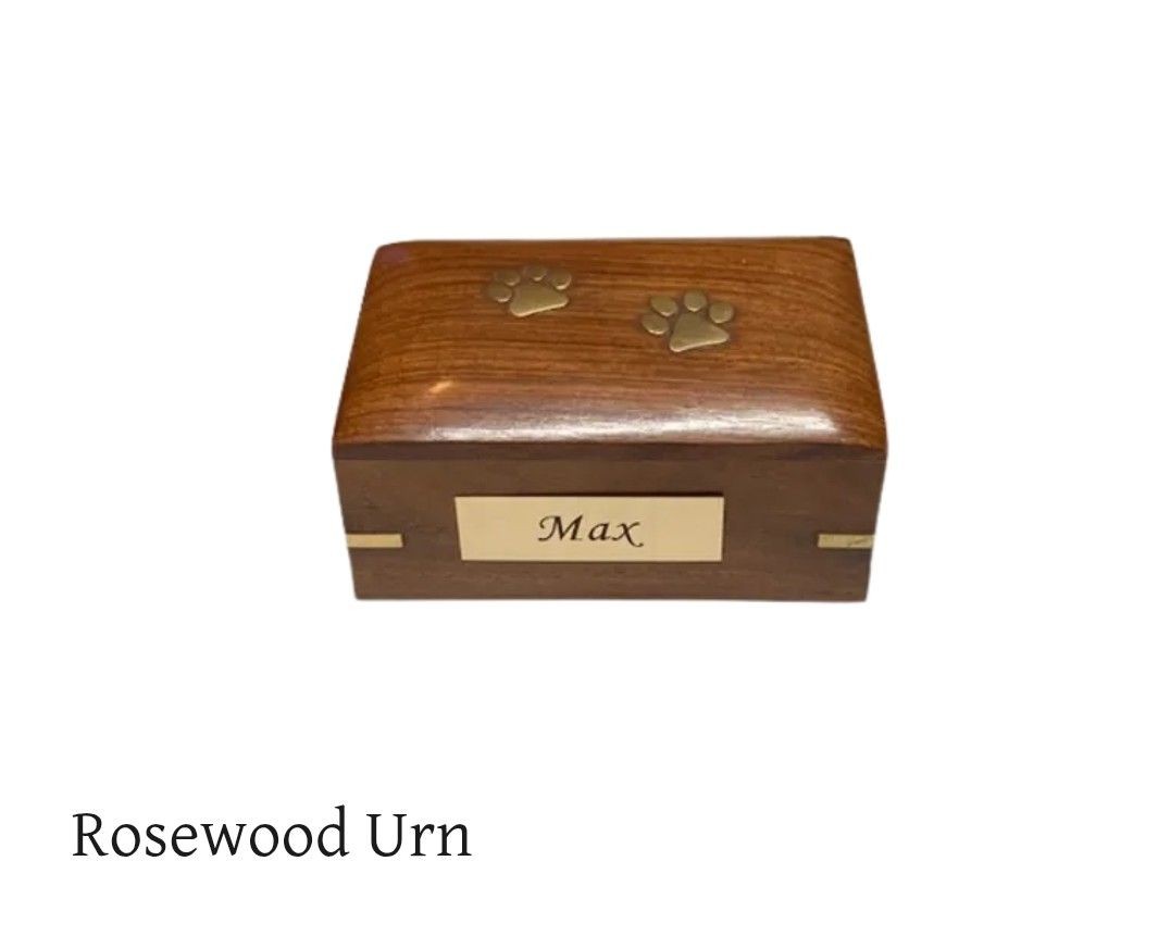 Wooden urn with paw prints and engraved nameplate 'Max' on the front.